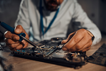 Image showing Man hands, it or soldering motherboard in engineering workshop for night database fixing. Zoom, technician or circuit board tools in repair, maintenance or upgrade in information technology industry