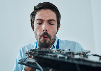 Image showing Information technology, fixing motherboard circuit and man blow dust from electronics, semiconductor or computer hardware. CPU system maintenance, service industry face and IT worker repair microchip