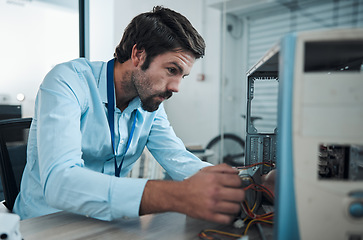 Image showing Serious man, it or technician fixing computer, PC or processor in engineering service workshop. Worker, CPU or hardware for repair, maintenance or software upgrade in information technology industry