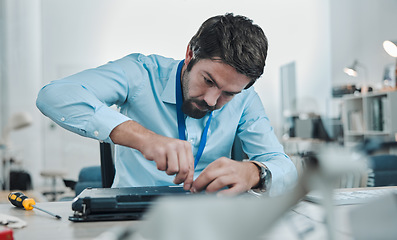 Image showing Laptop, repair and concentration with an engineer or handyman fixing hardware in an IT office. Computer, information technology or maintenance with a male service professional at work on electronics