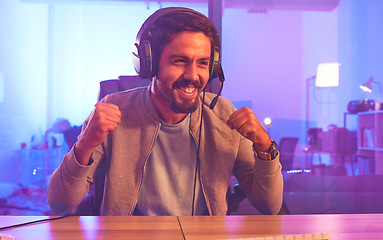 Image showing Winner, wow or man gamer on computer with microphone celebrating game win and success fist. Happy, cheering or esport player celebration for online competition, excited with progress and achievement