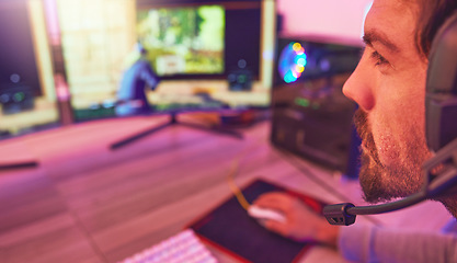 Image showing Computer gamer, man and face with headphones for esports, online games or virtual competition in dark room. Gaming guy, video game player and live streaming on headset in neon lighting, tech or night