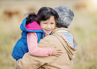 Image showing Hug, happy and portrait of a child with grandmother on a farm for bonding, playing and walking. Smile, affection and girl hugging a senior person while on a walk in the countryside for quality time