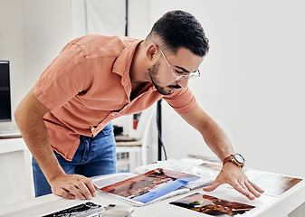 Image showing Photographer person looking at photos for photography portfolio, photoshoot results thinking, decision and choice. Professional designer or serious man analysis of images on desk for print catalog