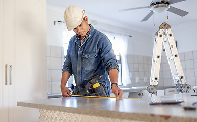 Image showing Construction, measurement and handyman doing home repair, renovation and building a counter. Service, contractor and builder busy with house improvement, installation and maintenance in a kitchen