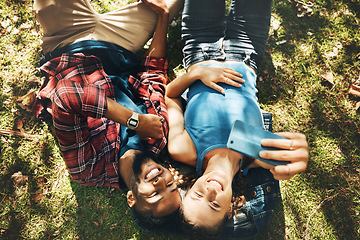 Image showing Top view, interracial couple and happy selfie in park, garden and grass in sunshine, date and nature. Young man, woman and diversity people taking photograph outdoor for love, care and social media