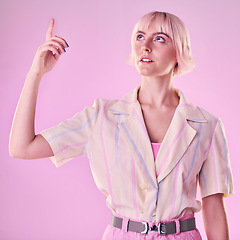 Image showing Woman, mockup and pointing up to studio on pink background for advertising wall color. Female model, hands and press information on cyberpunk system, gen z fashion and user network backdrop space