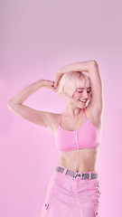 Image showing Fashion, dance and woman isolated on pink background listening to music with cosmetics and pastel aesthetic. Happy, gen z model or person dancing with audio for fun, freedom and self love in studio