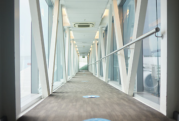 Image showing Airport backgrounds, terminal hallway and corridor for traveling, journey and covid transport regulations. Empty walkway for airplane flight, immigration and interior design tunnel space for walking