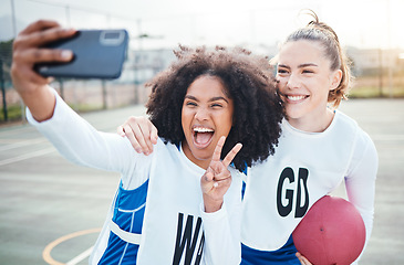 Image showing Black woman, friends and smile with peace sign for selfie, netball or social media post on the court. Happy sporty women smiling for profile picture, photo or vlog in memory for sports day together
