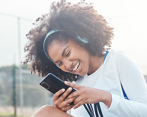 Image showing Netball sports, phone music and black woman listening to mp3 radio, audio podcast or playlist song after training workout. Laughing, online digital headphones and athlete streaming funny meme video