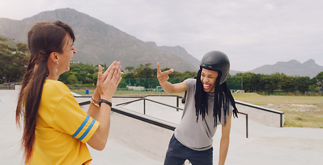 Image showing Laughing, funny and interracial couple bonding while roller skating and learning to click fingers. Playful, applause and woman clapping for a black man clicking while on skates at a park for fun