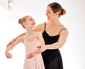 Image showing Ballet, learning class and dance teacher with child student in studio for dancing, art and coaching. Girl smile with woman ballerina coach or dancer to learn balance and academy performance with arms