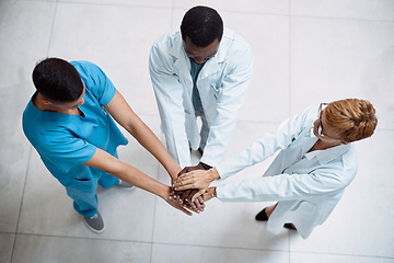 Image showing Doctor, meeting and hands together above for collaboration, healthcare or teamwork unity in trust. Top view of doctors piling hand in medical agreement, strategy or partnership for team solidarity