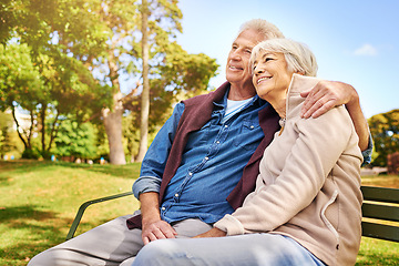 Image showing Park, thinking and love with a senior couple sitting on a bench together on a summer day for romance. Nature, garden or memory with a mature man and woman bonding outdoor during retirement