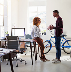 Image showing Conversation, idea and black woman with man in office sharing opinion and meeting for creative project. Teamwork, planning proposal and employees in casual discussion at tech startup or design agency