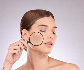 Image showing Woman, magnifying glass and face in studio for beauty, cosmetics and dermatology. Facial magnifier, female model and check skincare, aesthetic wellness and inspection for acne, laser and search pores