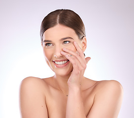 Image showing Skincare, woman and touch face in studio for beauty, dermatology or wellness cosmetics on background. Happy female model, smile and aesthetic glow of shine, laser transformation or facial spa results