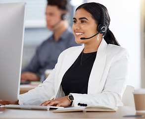 Image showing Happy woman, call center and computer with headset in telemarketing, customer service or support at office. Friendly female consultant or agent with mic sitting by desktop PC in contact us for sales