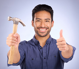 Image showing Man, studio and portrait with thumbs up and hammer for handyman, maintenance or repair work with smile. Happy asian model person on purple background for engineer, mechanic or technician job tools