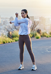 Image showing Fitness, arm and stretching by woman in road for running, training and exercise at sunset, body or warm up. Runner, stretch and mindset by girl at sunrise for cardio, marathon or outdoor practice run