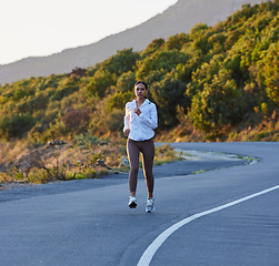 Image showing Road, fitness and woman running, exercise and morning cardio, focus and positive mindset. Runner, training and girl outdoor for speed, walking and marathon, endurance and practice along nature