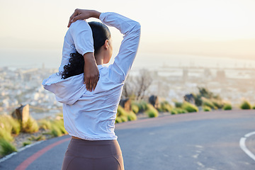Image showing Fitness, stretching and arm by woman rear view in road for running, training and exercise at sunset. Runner, stretch and back of girl at sunrise for cardio, marathon or outdoor practice run workout