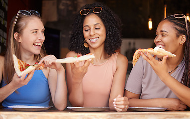 Image showing Woman, friends and smile for pizza, food or eating at restaurant together in friendship. Happy hungry women smiling and relaxing on fun date, socializing or bonding at cafe enjoying Italian meal