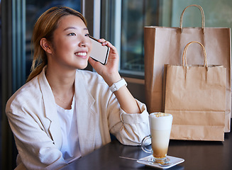 Image showing Phone call, shopping mall and Asian woman in cafe with coffee talking, chatting and in conversation. Communication, fashion and happy girl on mockup smartphone for discount news, retail deal and sale