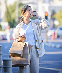Image showing Phone call, shopping bag and smile of Asian woman with mobile mockup screen on city street. Retail customer, chat and happiness of a young person with paper bags from shop sale or store discount