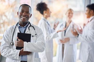 Image showing Black man, doctor portrait and tablet with medical team in hospital ready for healthcare work. Wellness, health and medic employee in a clinic feeling happiness and success with blurred background