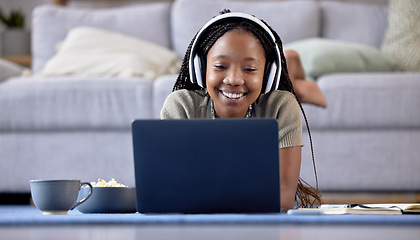 Image showing Black woman, student and laptop with smile for elearning, education or entertainment by living room sofa at home. Happy African American female learner smiling on computer lying on lounge floor