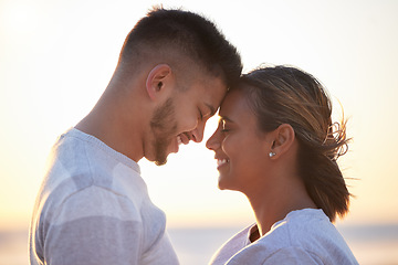 Image showing Couple, sunset forehead touch for love, outdoor beach date and happy holiday together. Man, woman and face of relationship at ocean for freedom, support and relax with trust, peace and smile of care