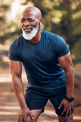 Image showing Black man, running break and breathing for fitness, exercise and workout in nature, park or garden. Senior male, sports rest and smile for motivation, health and outdoor wellness training with music