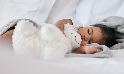 Image showing Sleeping, teddy bear and relax with baby in bedroom for cute, comfortable and dreaming. Innocence, young and rest with tired child at home for and napping with toy for bedtime, youth and sweet