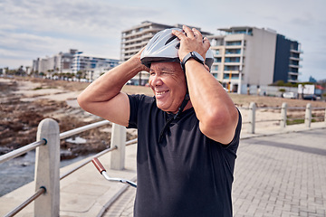 Image showing Senior man, smile and helmet at the beach with bicycle for weekend, trip or holiday travel in Cape Town. Happy elderly male biker or cyclist smiling for cycling, journey or break by the ocean coast