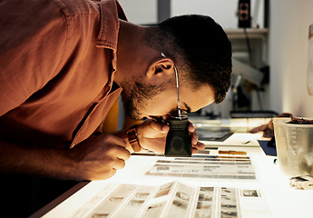 Image showing Man, photographer and magnifying glass for film negatives, zoom and analysis for photo journalist job. Photography expert, analyse picture and focus in studio for choice, art decision and creativity