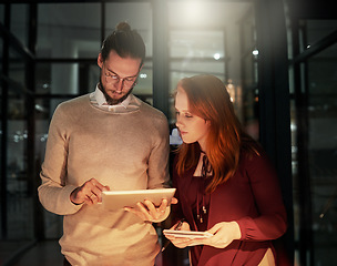 Image showing Man, tablet and office in night with woman, planning or web design with check, notebook and team strategy. Teamwork, it goals and ux designer group for ideas, vision and dark workplace for analysis