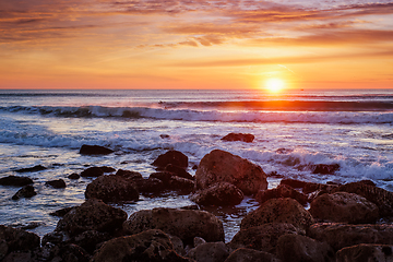Image showing Atlantic ocean sunset with waves and rocks. Costa da Caparica, Portugal