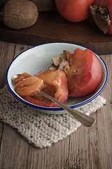 Image showing Persimmon fruit on rustic table