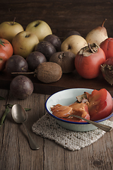 Image showing Persimmon fruit on rustic table