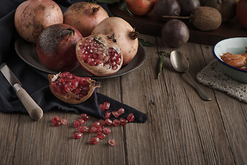 Image showing Pomegranate fruit on rustic table