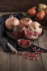 Image showing Pomegranate fruit on rustic table