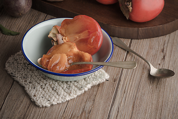 Image showing Persimmon fruit on rustic table