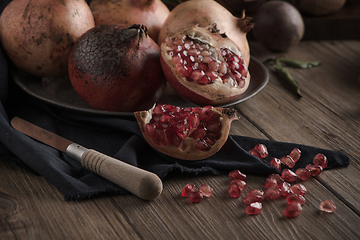 Image showing Pomegranate fruit on rustic table