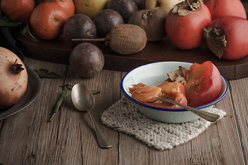 Image showing Persimmon fruit on rustic table