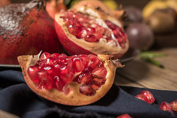 Image showing Pomegranate fruit on rustic table