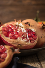 Image showing Pomegranate fruit on rustic table