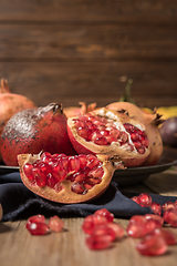 Image showing Pomegranate fruit on rustic table