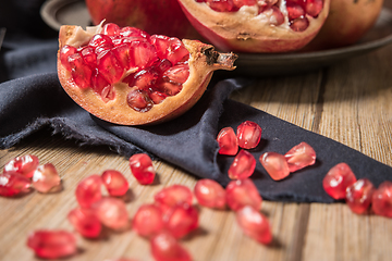 Image showing Pomegranate fruit on rustic table